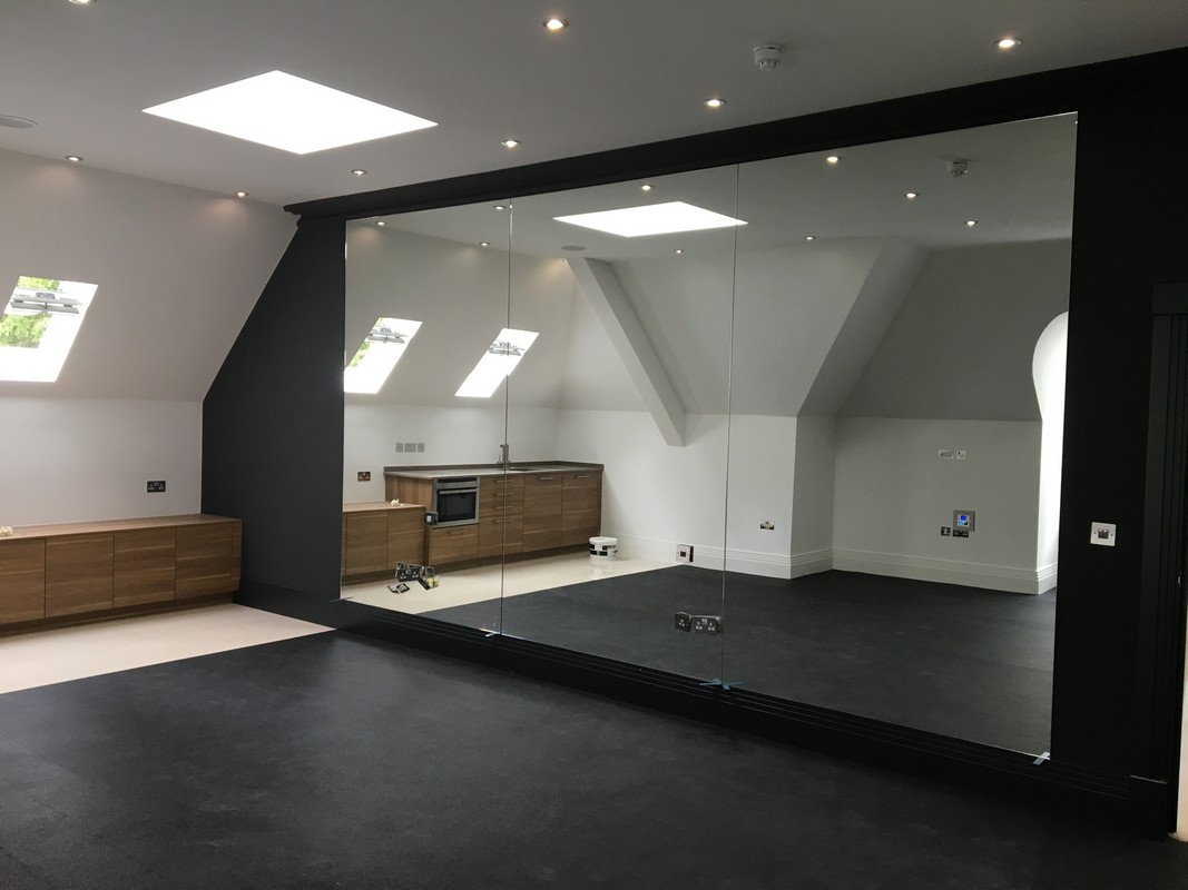 Frameless glass wall dividing loft conversion in Ladbroke Grove